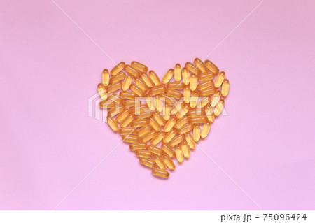 The heart laid out from the vitamin lies on the background.  75096424