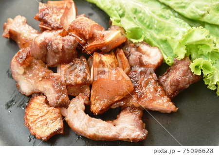 grilled pork neck and ear slice with lettuce on plate dipping spicy sauce grilled pork neck and ear slice with lettuce on plate dipping spicy sauce 75096628