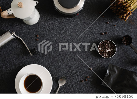coffee cup and moka pot on black table background in kitchen room, coffee shop. coffee cup and moka pot on black table background in kitchen room, coffee shop. 75098150