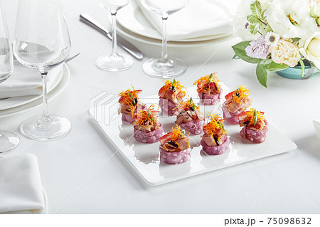 Outdoor catering banquet in summer. Table with snacks and canapes at a summer banquet Outdoor catering banquet in summer. Table with snacks and canapes at a summer banquet 75098632