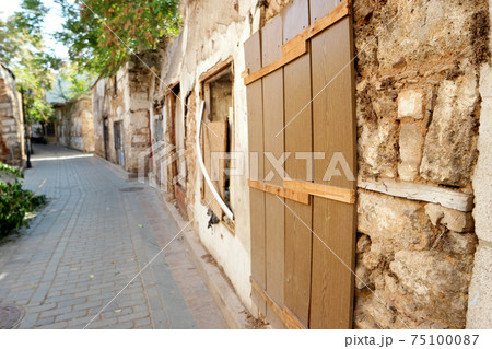 Background of stone wall with boarded window. 75100087