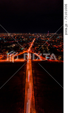 Panorama of night aerial view of the city of Ivano-Frankivsk, bright lights from cars and night lighting of the city. 75101006