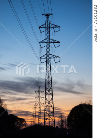 High-voltage power lines at sunset in winter, Finland. 75101282
