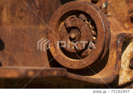 Rusty metal parts of an old and abandoned tractor, Aragon, Spain. 75102947