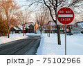 Do not enter sign on the residential building background, entry is prohibited. Winter, snowfall in North American suburban. Icey, snowy street 75102966