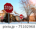 Do not enter sign on the residential building background, entry is prohibited. Winter, snowfall in North American suburban. Icey, snowy street 75102968