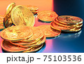 Cryptocurrency Bitcoin golden coins spilling on the table. 75103536