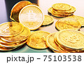 Cryptocurrency Bitcoin golden coins spilling on the table. 75103538