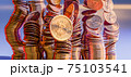 Cryptocurrency Bitcoin golden coins spilling on the table. 75103541