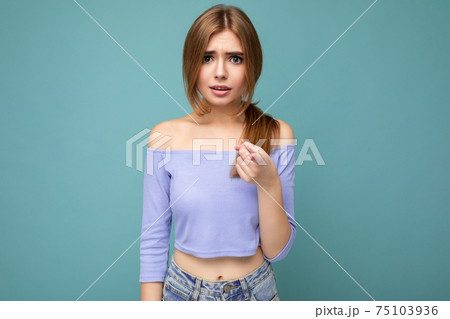 Photo portrait of young nice beautiful blonde woman with sincere emotions wearing trendy blue crop Photo portrait of young nice beautiful blonde woman with sincere emotions wearing trendy blue crop 75103936