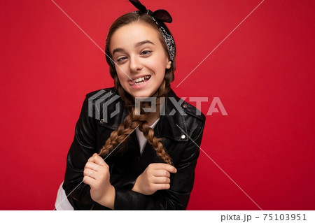 Photo shot of pretty positive smiling brunette little female teenager with pigtails wearing stylish 75103951