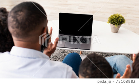 Black family having videocall using laptop with empty screen Black family having videocall using laptop with empty screen 75103982