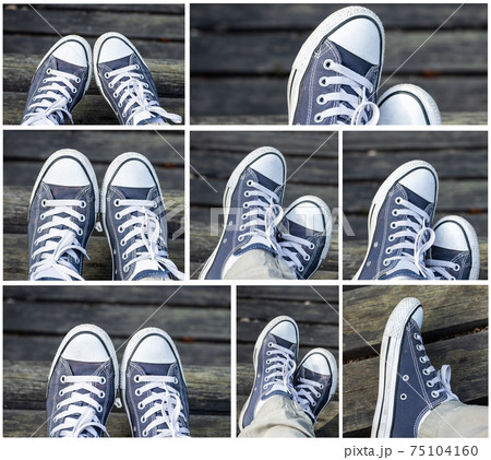 Set of blue sneakers on the feet on wooden background. Top view. 75104160