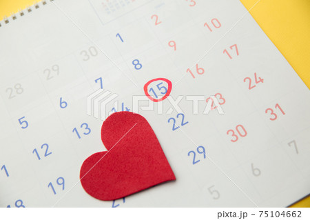Red heart with red highlighter with ovulation day mark on calendar. Gynecology concept Red heart with red highlighter with ovulation day mark on calendar. Gynecology concept 75104662