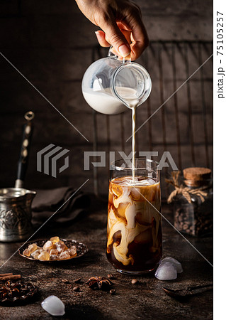 Ice coffee in a tall glass 75105257