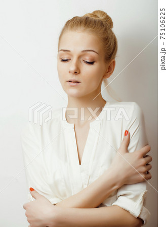 young blond woman on white backgroung gesture thumbs up, isolated emotional posing close up, lifestyle people concept young blond woman on white backgroung gesture thumbs up, isolated emotional posing close up, lifestyle people concept 75106225