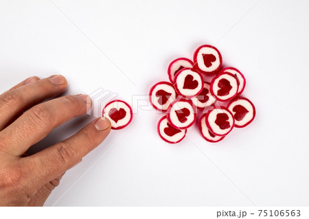 Sweets and health. Candies in the form of hearts on a white background 75106563