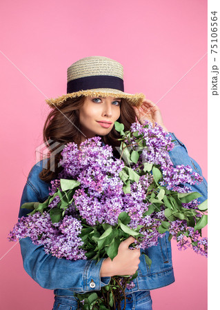 Happy smiling woman enjoying smell of bouquet lilac flowers over Happy smiling woman enjoying smell of bouquet lilac flowers over 75106564