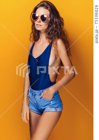 Woman wearing lingerie and sunglasses Woman wearing lingerie and sunglasses 75106826
