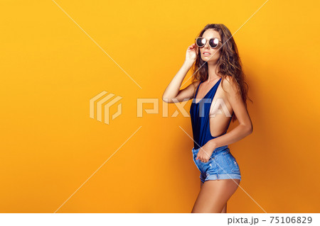 Woman wearing lingerie and sunglasses Woman wearing lingerie and sunglasses 75106829