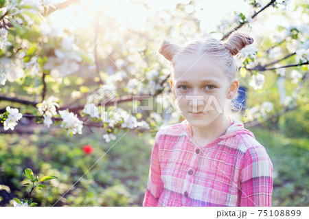Beautiful little girl in the garden Beautiful little girl in the garden 75108899