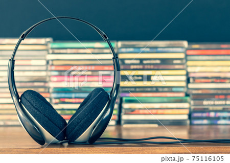 headphone on stack of cd background 75116105