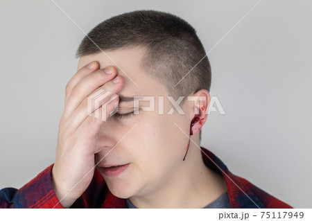 A man whose ear is bleeding. Vascular rupture, damage to the tympanic membrane, ear diseases, oncology, otitis media, myringitis 75117949