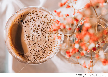 Cup of latte cappuccino. Morning coffee aesthetics vibes. Breakfast. Pink gypsophila flowers 75119650