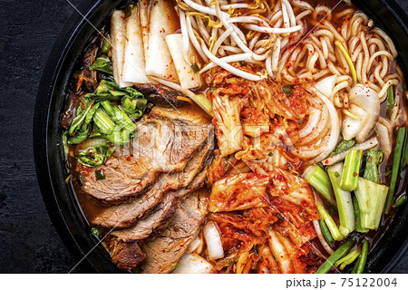 Traditional Korean kimchi jjigae with grilled pork belly and ramen 75122004