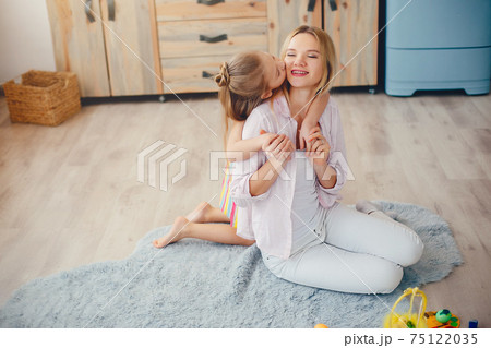 Mother with little daughter in a room 75122035