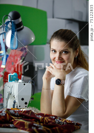 Young seamstress businesswoman at her workplace Young seamstress businesswoman at her workplace 75122835