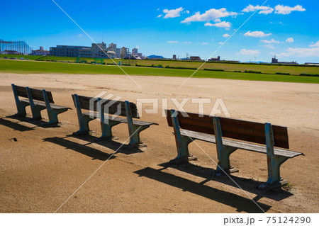 昼下がりの吉野川の河川敷のベンチの写真素材
