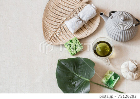 Top view spa composition with bath accessories, teapot and tea in a cup. Top view spa composition with bath accessories, teapot and tea in a cup. 75126292