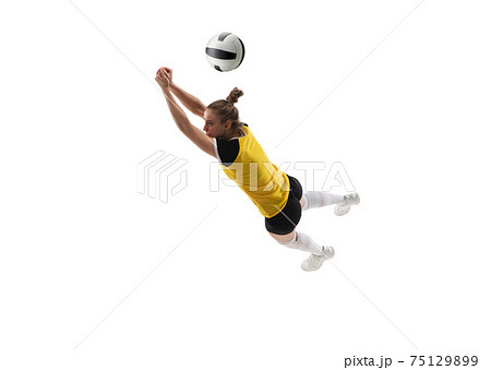 Young female volleyball player isolated on white studio background. Woman in sport's equipment training and practicing. 75129899