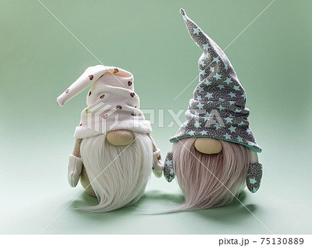 Cute bearded gnome in a cap on a light green background. Handmade soft toy. Home decor 75130889