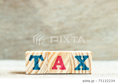 Alphabet letter block in word tax on wood background Alphabet letter block in word tax on wood background 75132234