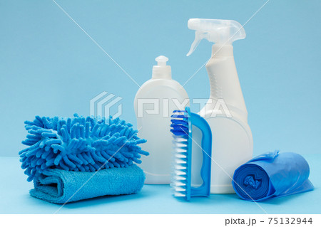Bottles of detergent, brush and sponges on the blue background. 75132944