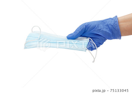 Female doctor in a glove holding a medical mask in his hand. 75133045