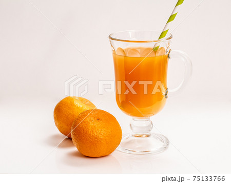 Fresh tropical fruits and a glass of juice on white background. Fresh tropical fruits and a glass of juice on white background. 75133766