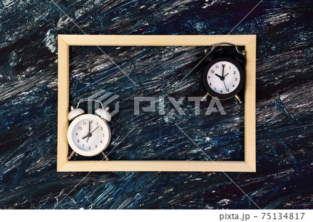 alarm clocks on a dark background with a space under the text. good night, healthy sleep. top view alarm clocks on a dark background with a space under the text. good night, healthy sleep. top view 75134817