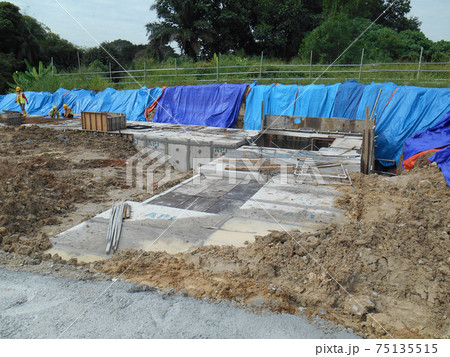 JOHOR, MALAYSIA -JANUARY 12, 2017: Underground onsite detention pond under construction at the construction site.  It is using precast concrete U channel box culvert as the main structure.  75135515