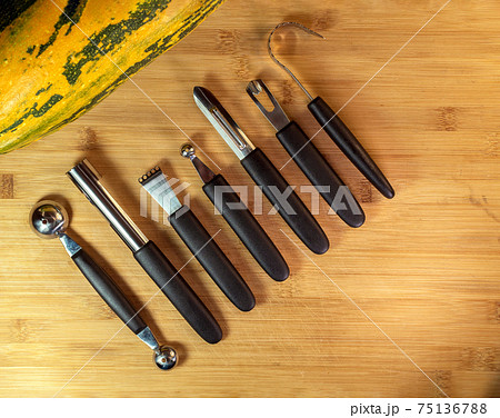 A tools kit for vegetable carving on the wood background. A tools kit for vegetable carving on the wood background. 75136788