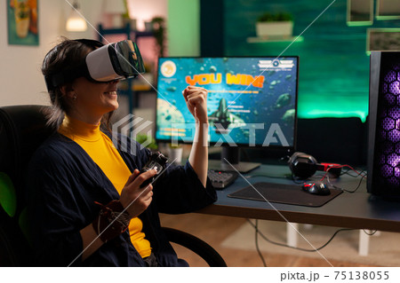 Winner player holding console playing virtual reality videogame Winner player holding console playing virtual reality videogame 75138055