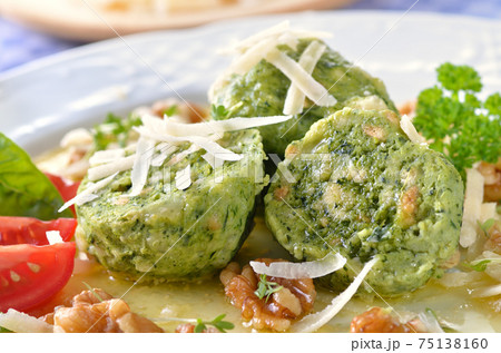 South Tyrolean bread dumplings with spinach and cheese, served with parmesan South Tyrolean bread dumplings with spinach and cheese, served with parmesan 75138160