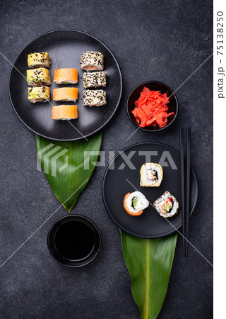 Traditional Japanese sushi rolls on dark background 75138250