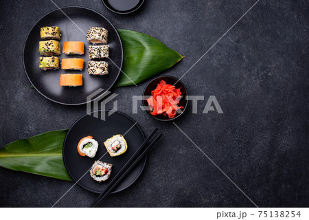 Traditional Japanese sushi rolls on dark background Traditional Japanese sushi rolls on dark background 75138254