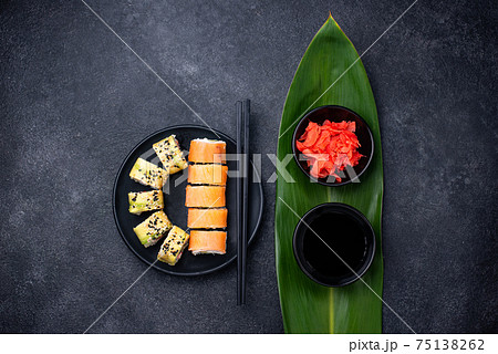 Traditional Japanese sushi rolls on dark background 75138262