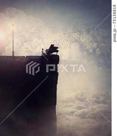 Person silhouette on the edge of a cliff sings and plays a piano song, as flock of birds flying out of the musical instrument. Surreal and inspirational scene above clouds. Adventure and music concept Person silhouette on the edge of a cliff sings and plays a piano song, as flock of birds flying out of the musical instrument. Surreal and inspirational scene above clouds. Adventure and music concept 75138819