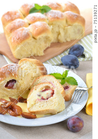 Sweet Austrian yeast pastry dumplings stuffed with plums and served with vanilla sauce 75139271