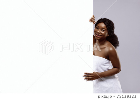 Beautiful Black Woman Wrapped In Towel After Bath Holding White Advertisement Board Beautiful Black Woman Wrapped In Towel After Bath Holding White Advertisement Board 75139323